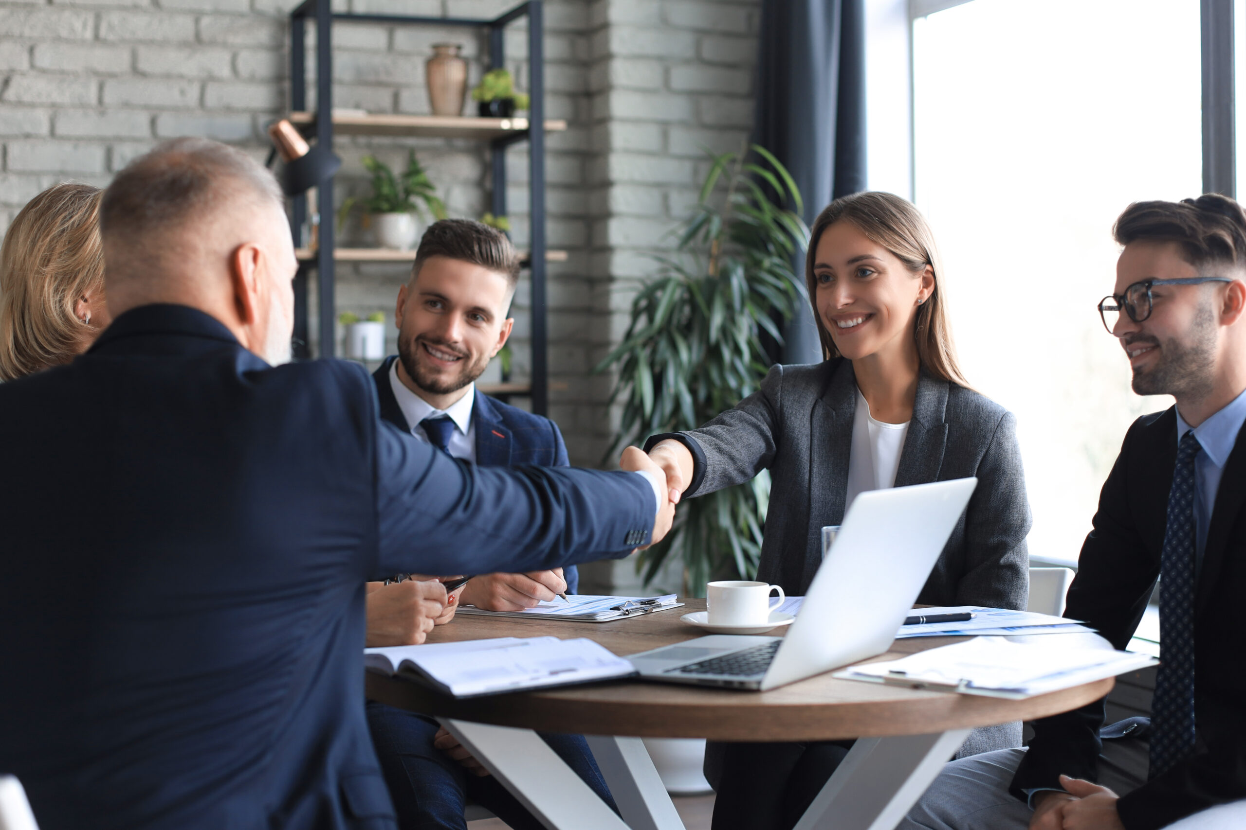 Business people shaking hands, finishing up a meeting.
